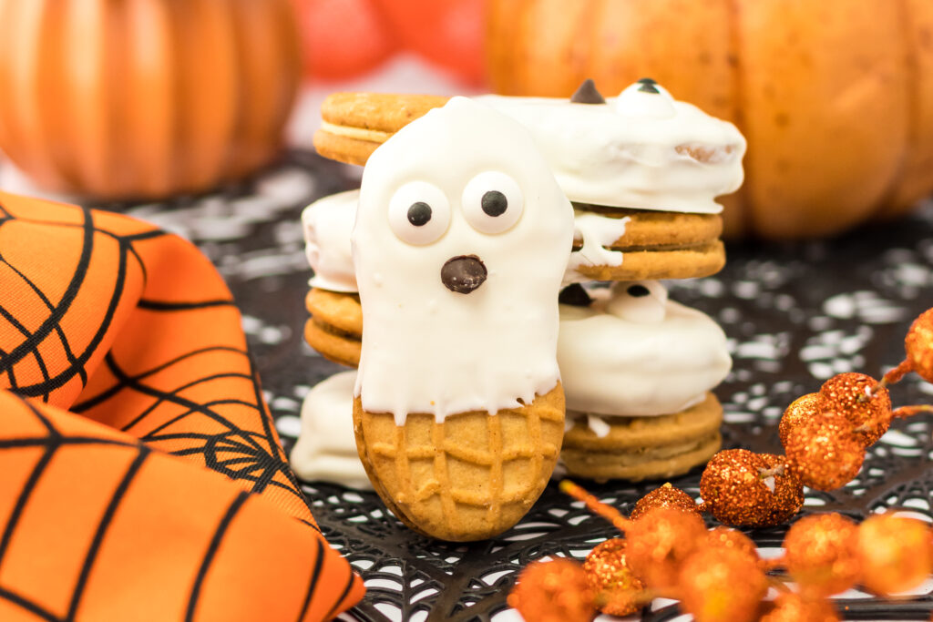 nutter butter ghost cookies on halloween decorated table