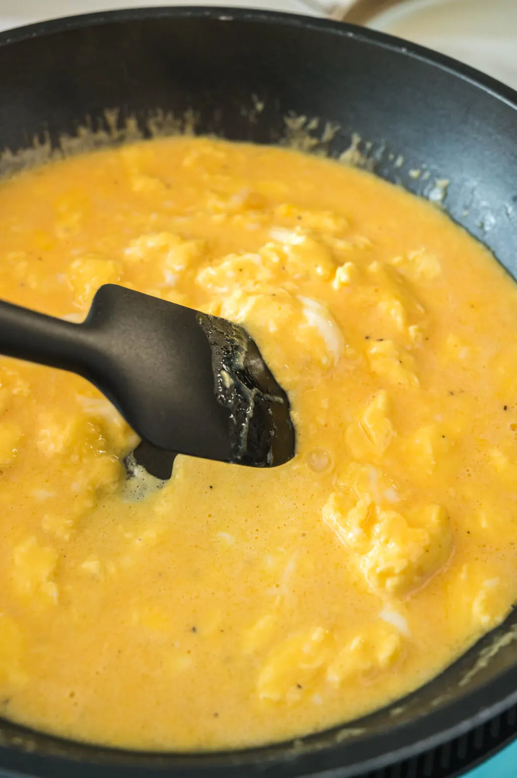 cooking scrambled eggs in a pan