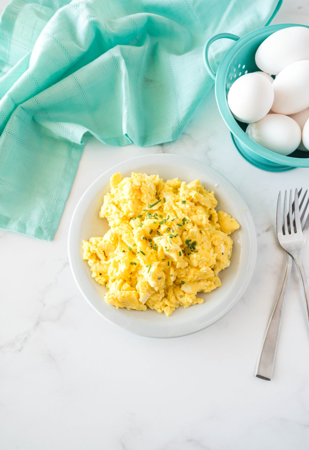 fluffy scrambled eggs on a white plate