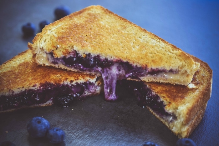 sliced of blueberry grilled cheese on table
