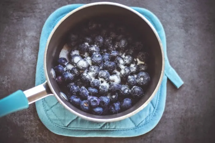 blueberries in sauce pan with sugar
