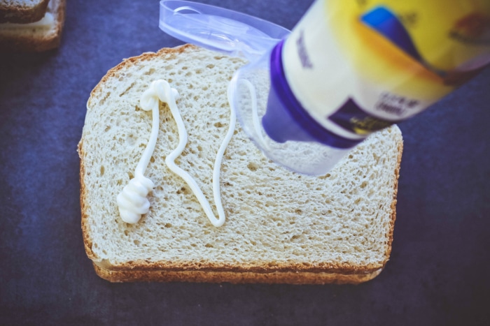 mayo being put on bread