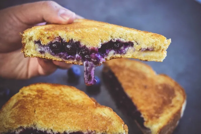 hand holding blueberry grilled cheese 