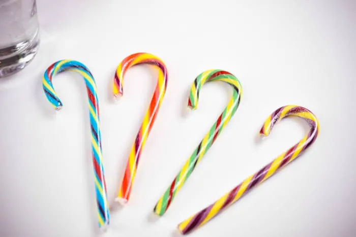 colorful candy canes on white table