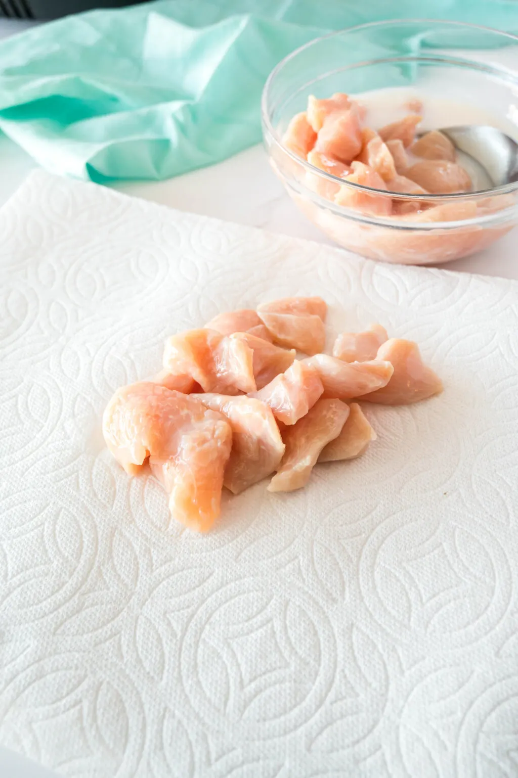 raw chicken pieces on a paper towel