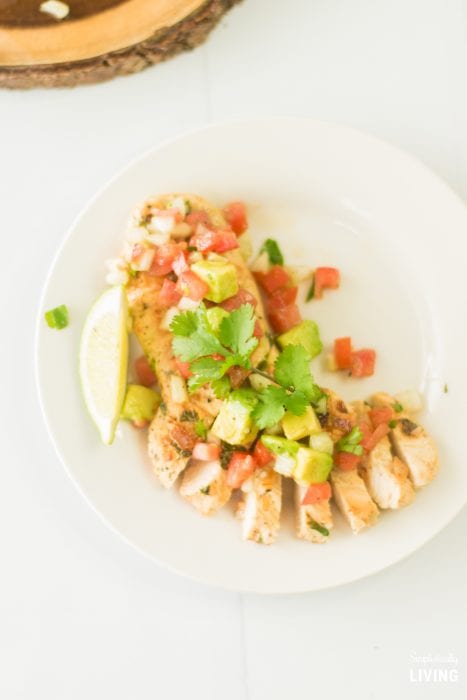 This Easy Cilantro Lime Chicken Recipe can be made in just a few minutes using boneless skinless chicken breasts, cilantro, lime and a homemade avocado, onion and tomato topping. It is the perfect low-carb recipe to get your body ready for Summer!