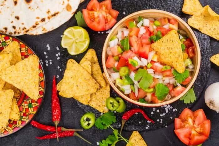This Easy Pico de Gallo Recipe can be made in just a few minutes using fresh tomatoes, onion, peppers, garlic, cilantro, lime and lemon. It adds the perfect amount of flavor and kick to any dish!