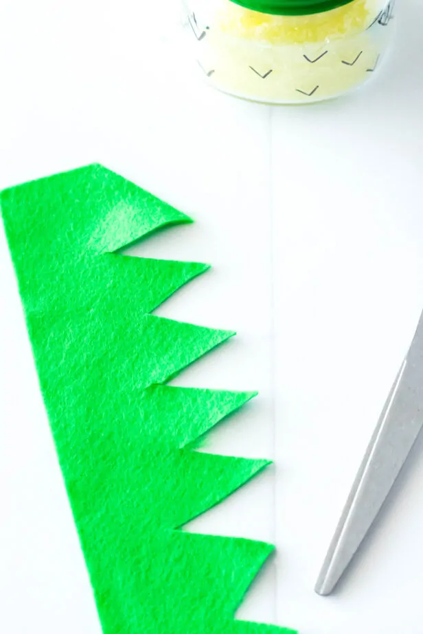 picture of green felt cut into a zig zag with scissors