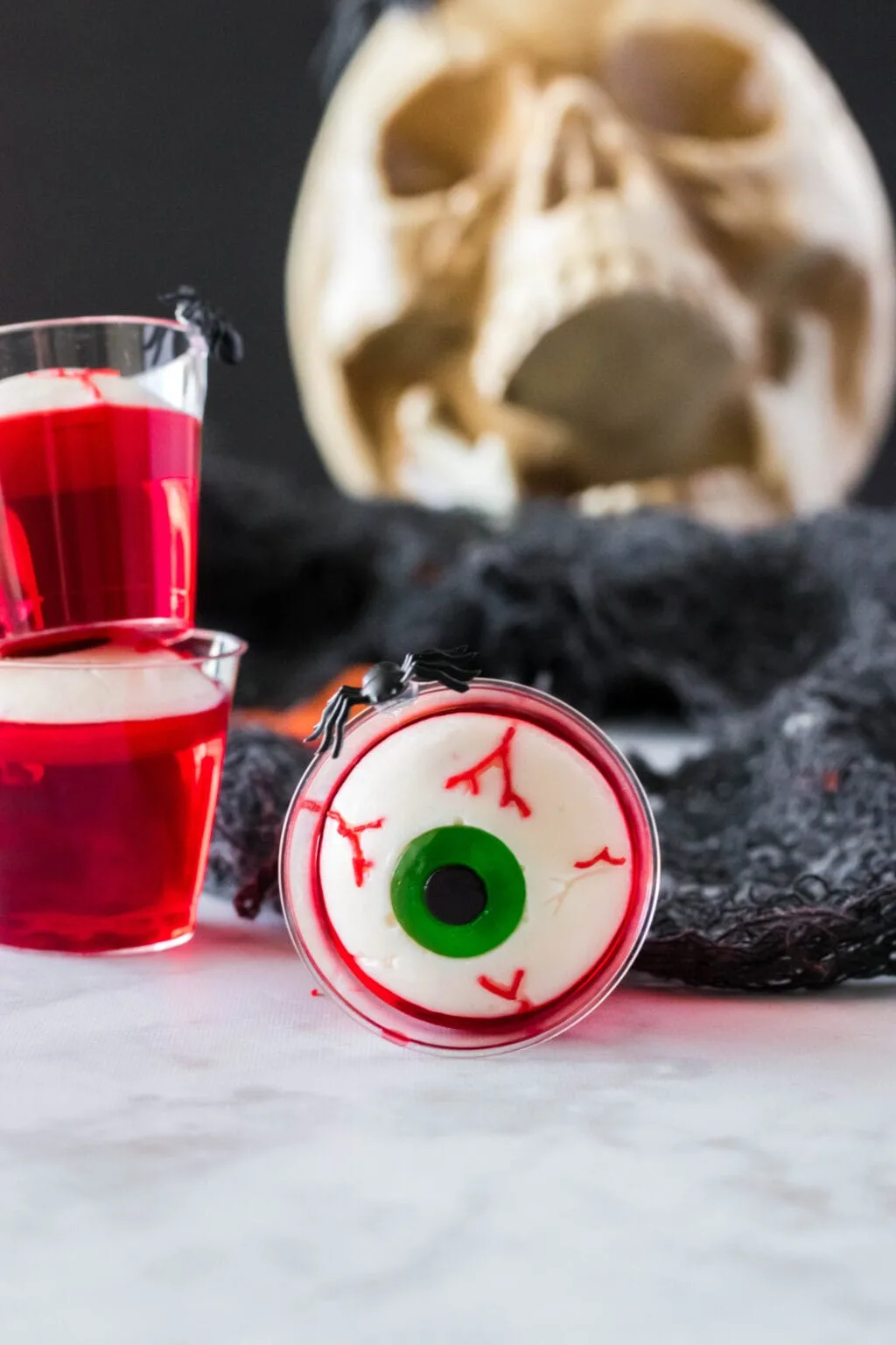 upclose photo of a red jello shot with gummy eyeball