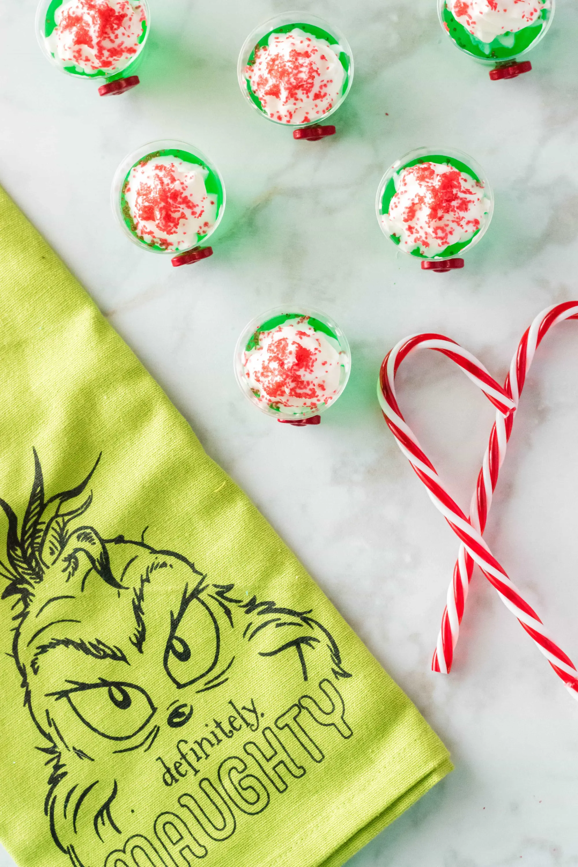 top view of grinch jello shots with a grinch themed towel