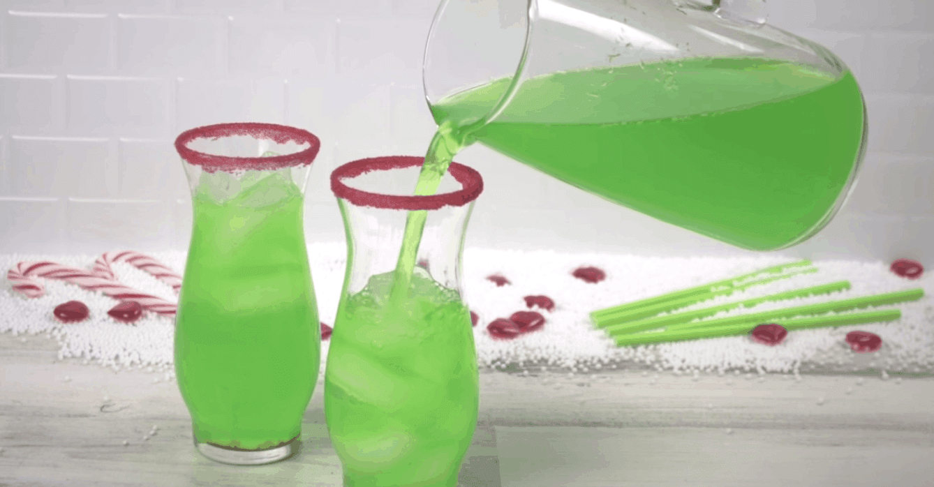 grinch punch being poured into glass with ice