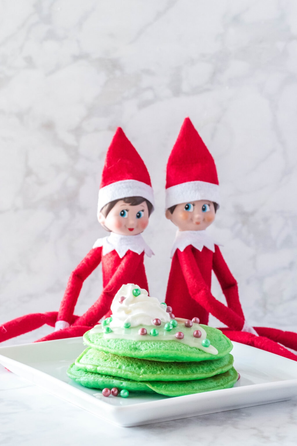 two elf on the shelf dolls with elf on the shelf pancakes