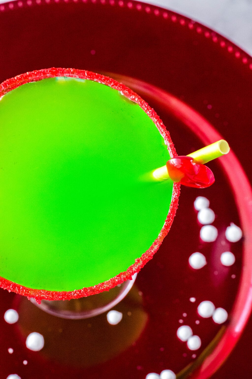 above shot of a grinch cocktail on a charger plate