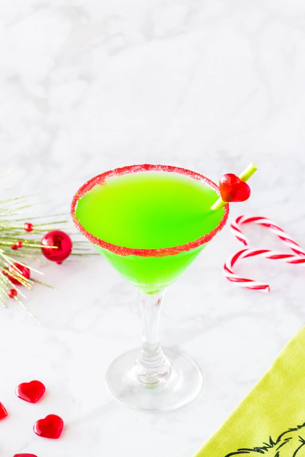 grinch cocktail with stirrer in glass