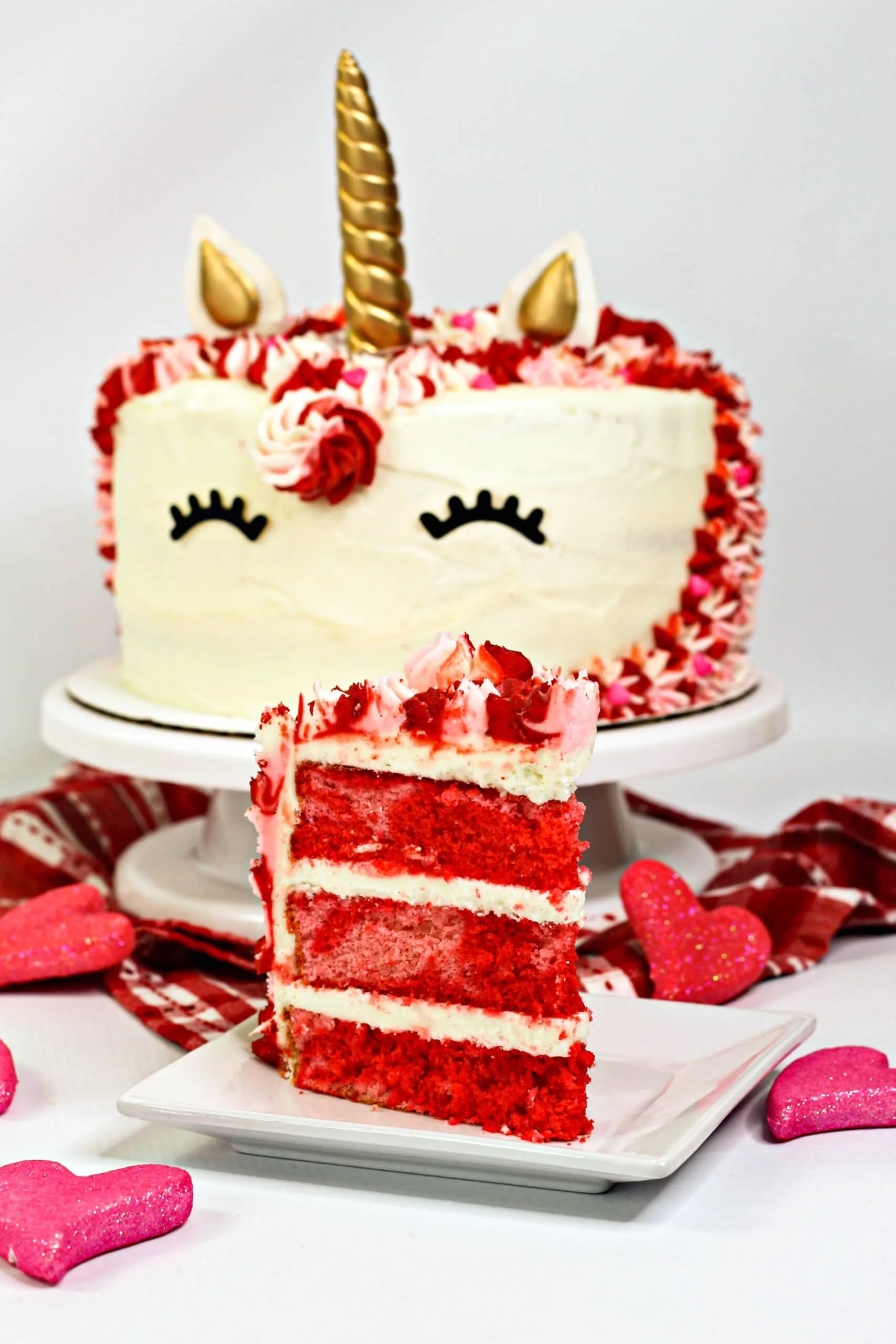 Valentine Unicorn Cake is the perfect homemade Valentine's Day treat. It is layered with pink and red vanilla cake and topped with homemade vanilla frosting.