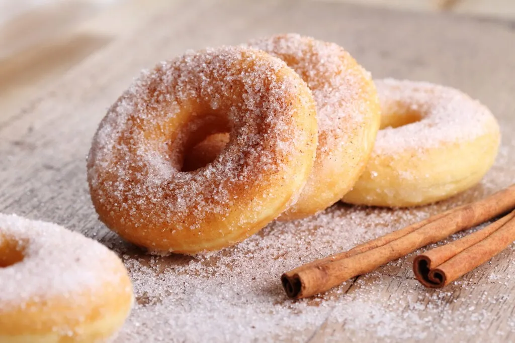 upclose cinnamon sugar donuts on a table