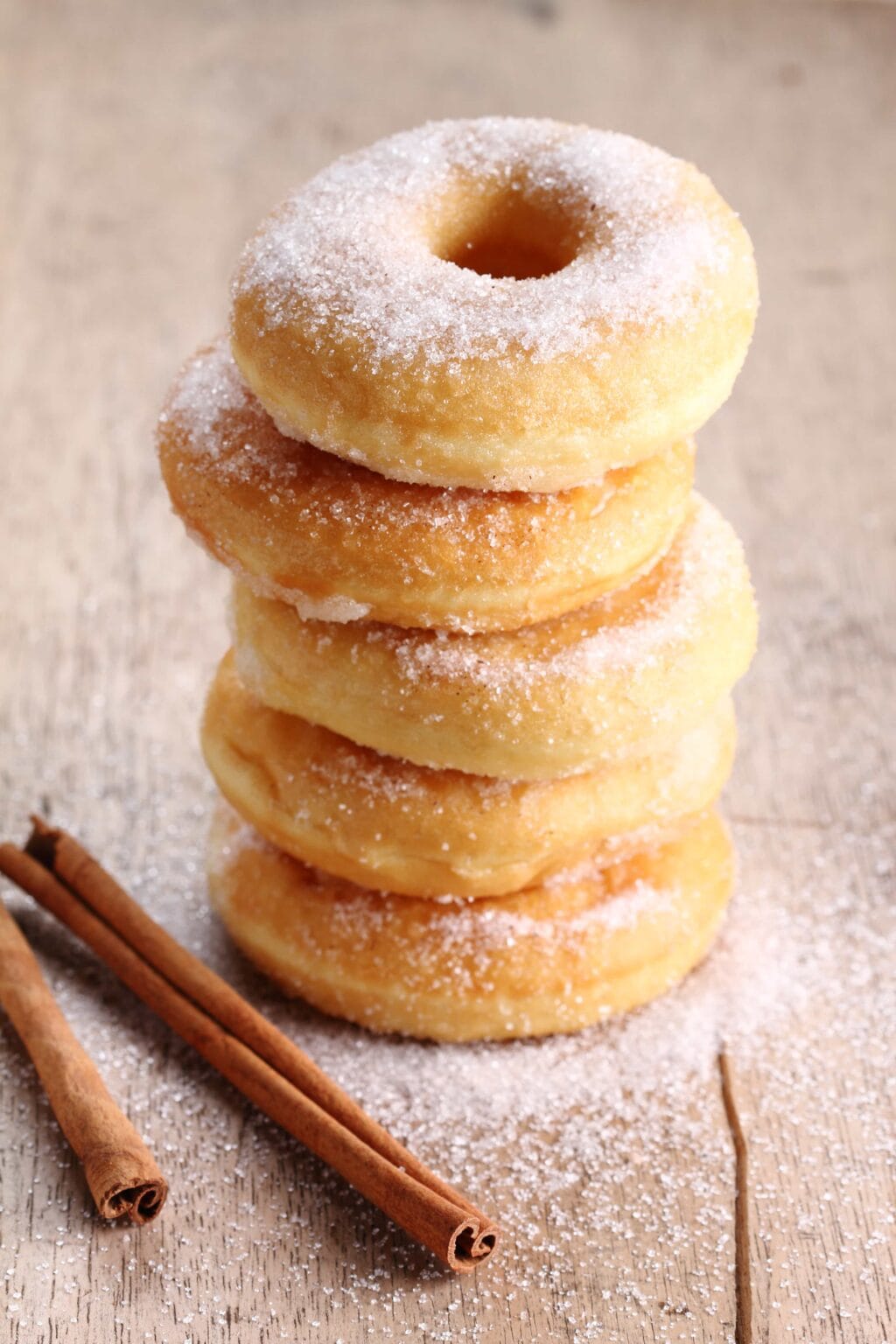 cinnamon sugar donuts stacked on a table