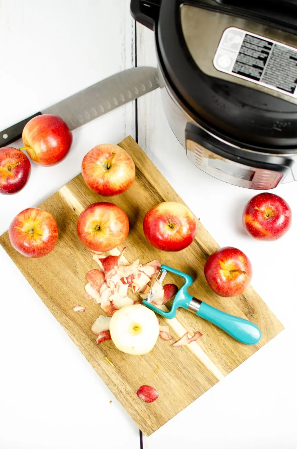 apples on a cutting board being peeled