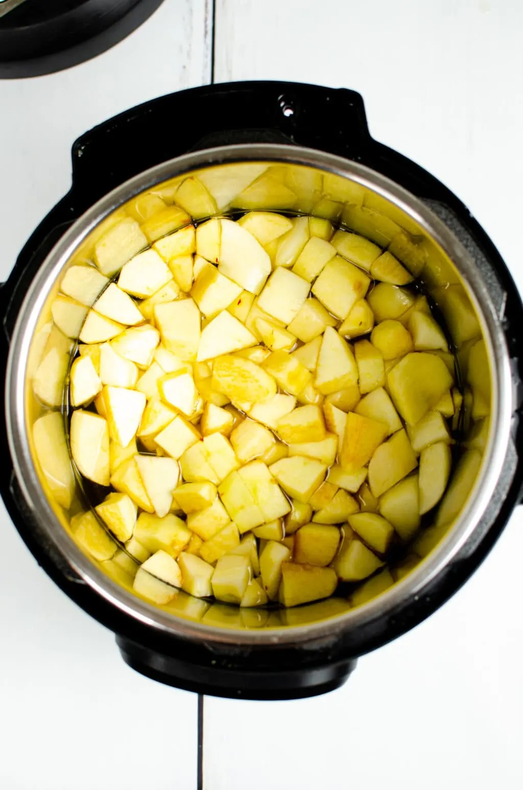 cut apple pieces in water inside an Instant Pot