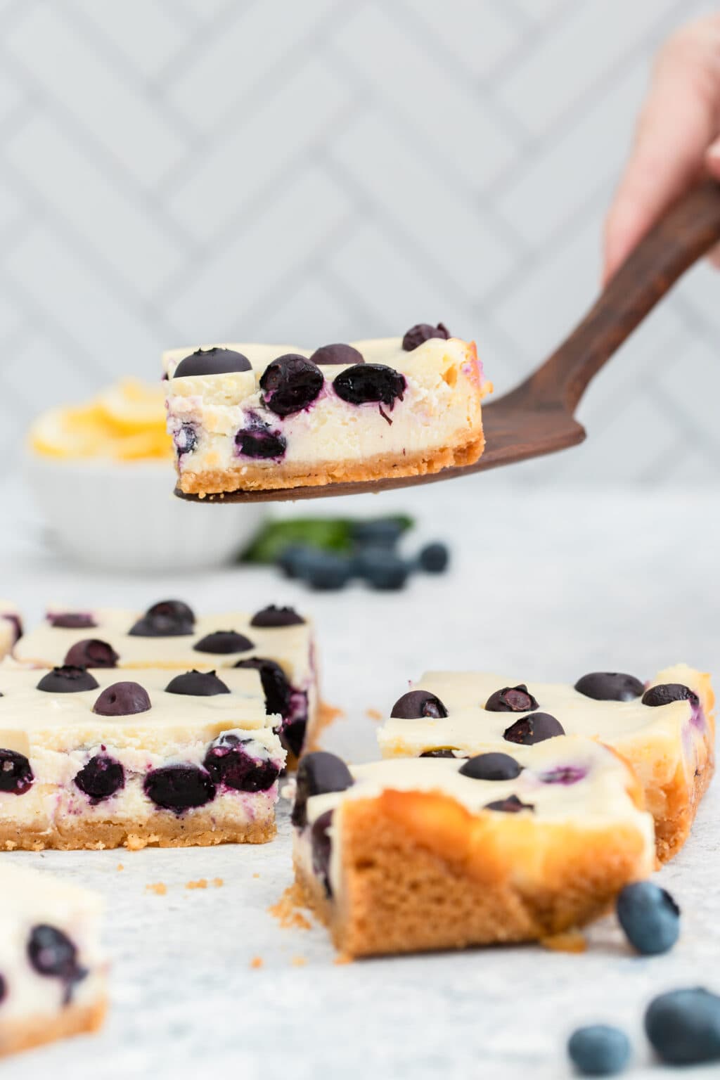 lemon blueberry cheesecake bar on a spatula 