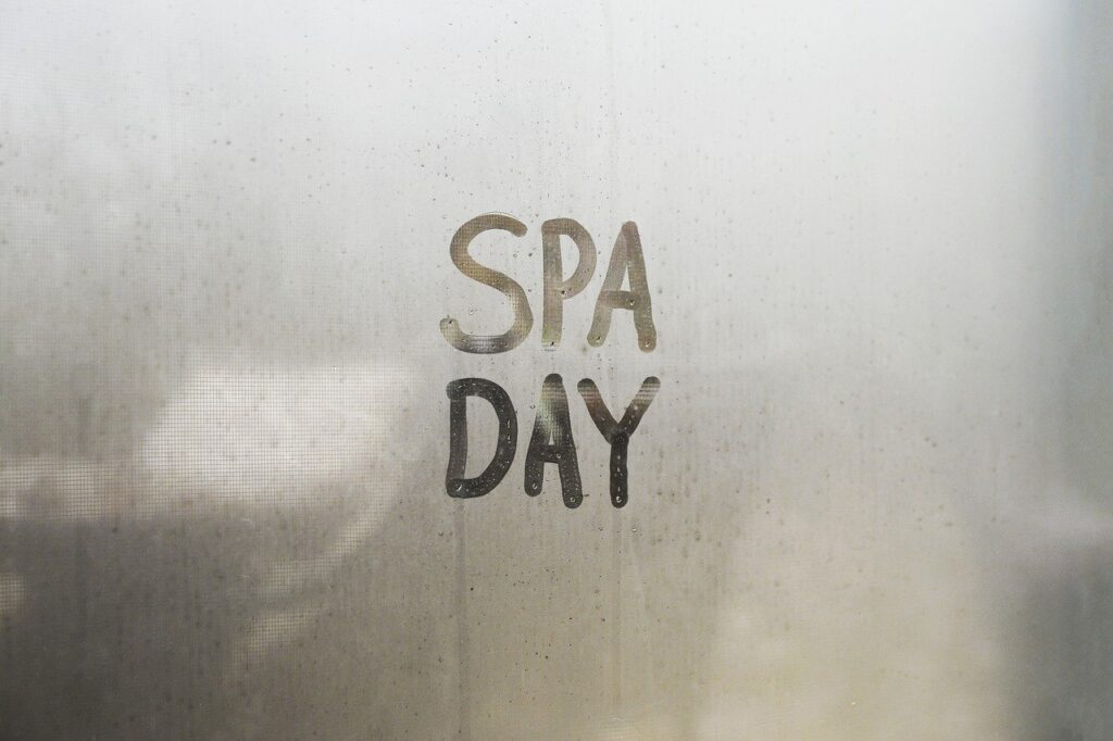 "spa day" written on a foggy window