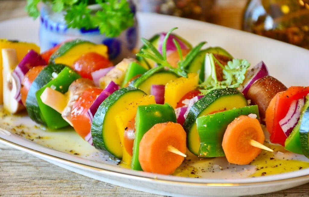 plate full of vegetables on skewers 