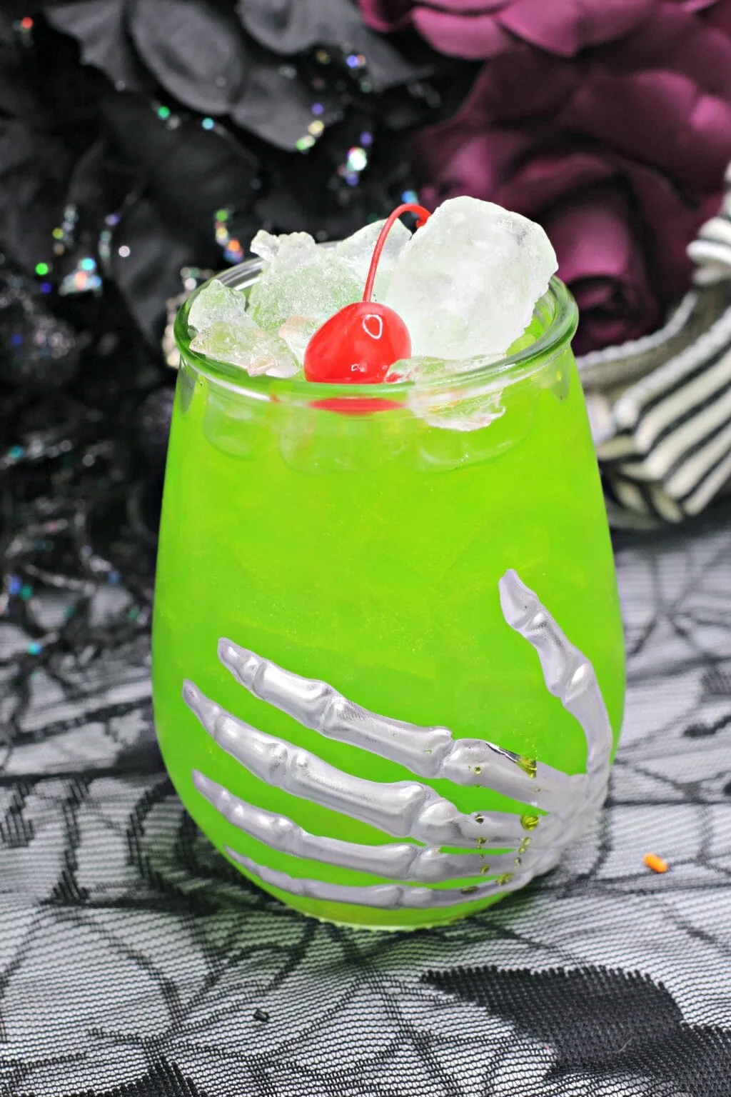 Green Halloween cocktail in a skeleton glass