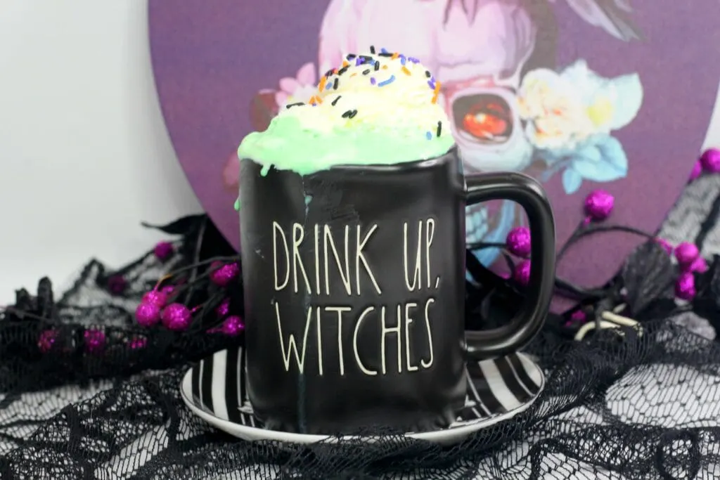 Rae Dunn Halloween mug that says "Drink Up, Witches" filled with Hocus Pocus Hot Cocoa