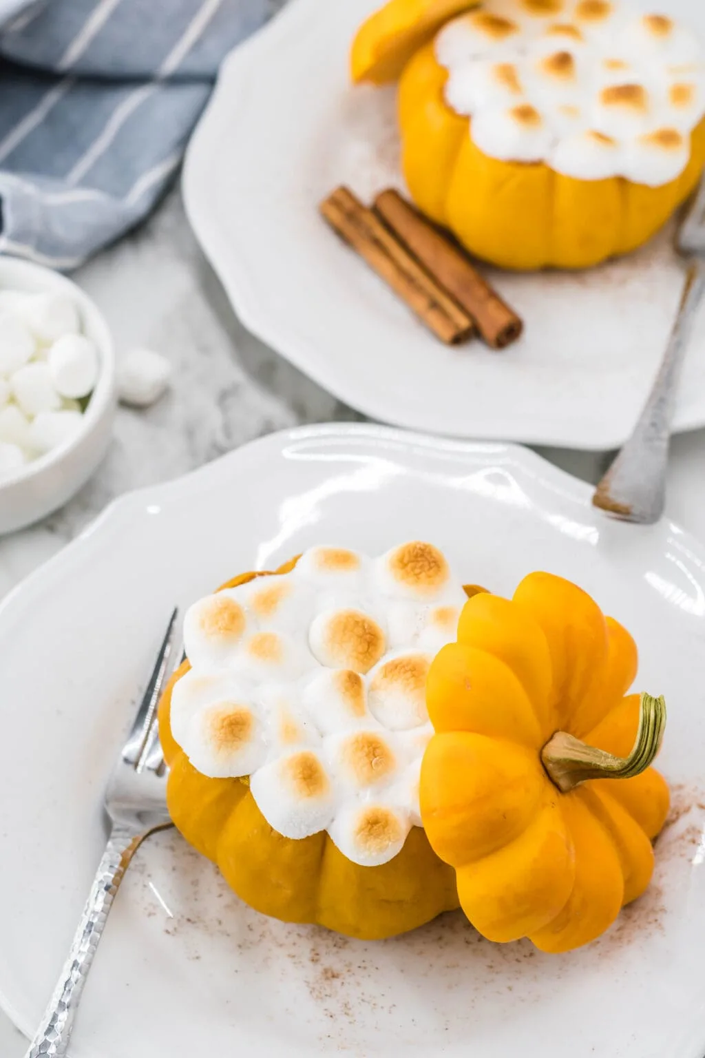 mini pumpkin with marshmallows on top on a plate