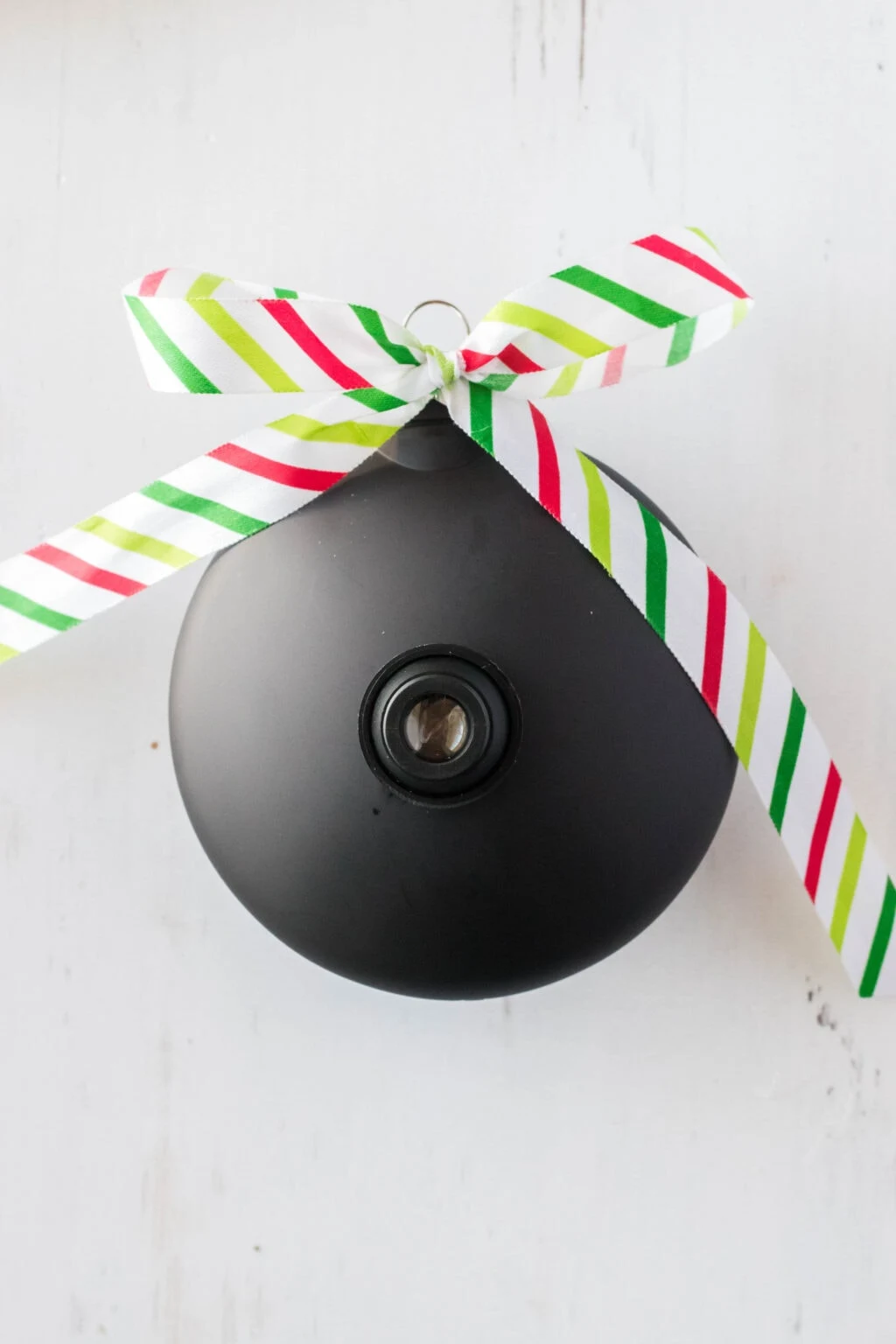 black ornament with christmas ribbon attached 