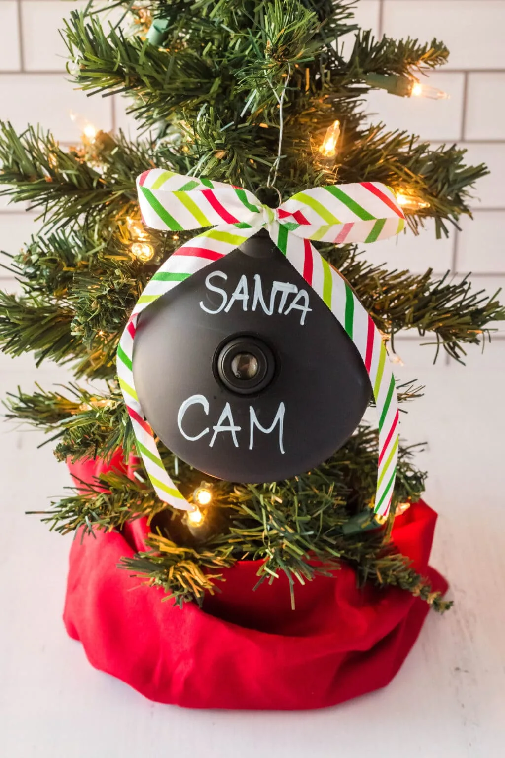 Santa cam ornament hanging on tree