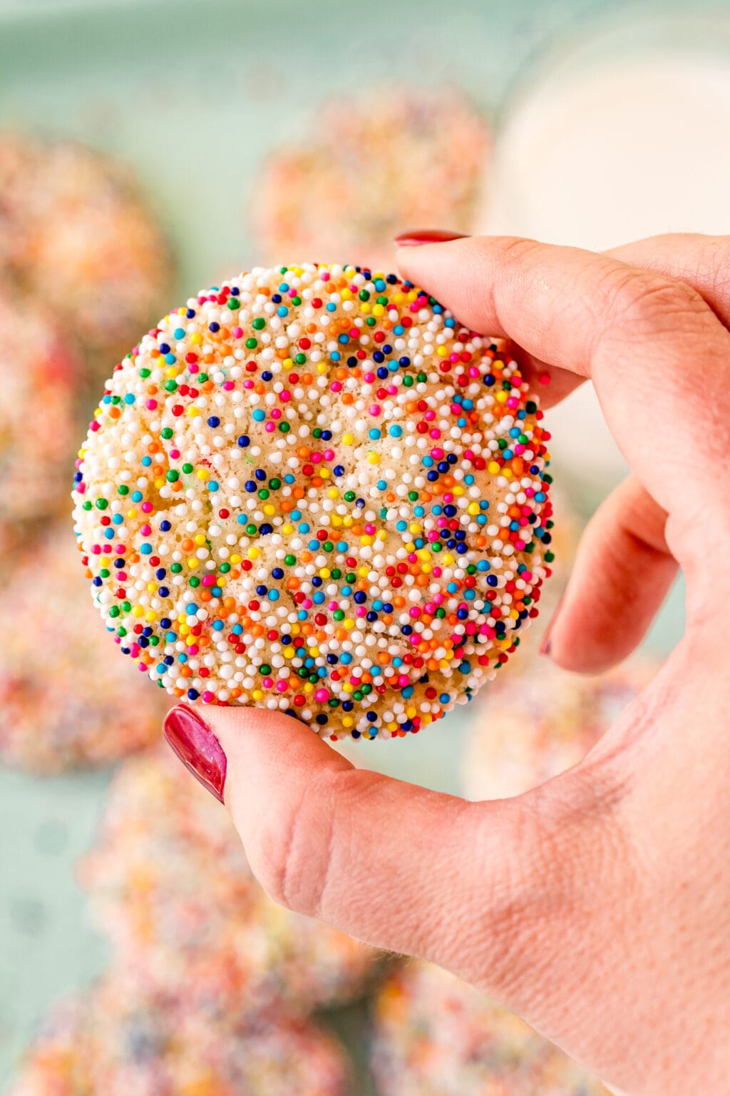woman's hand holding funfetti cake mix cookies