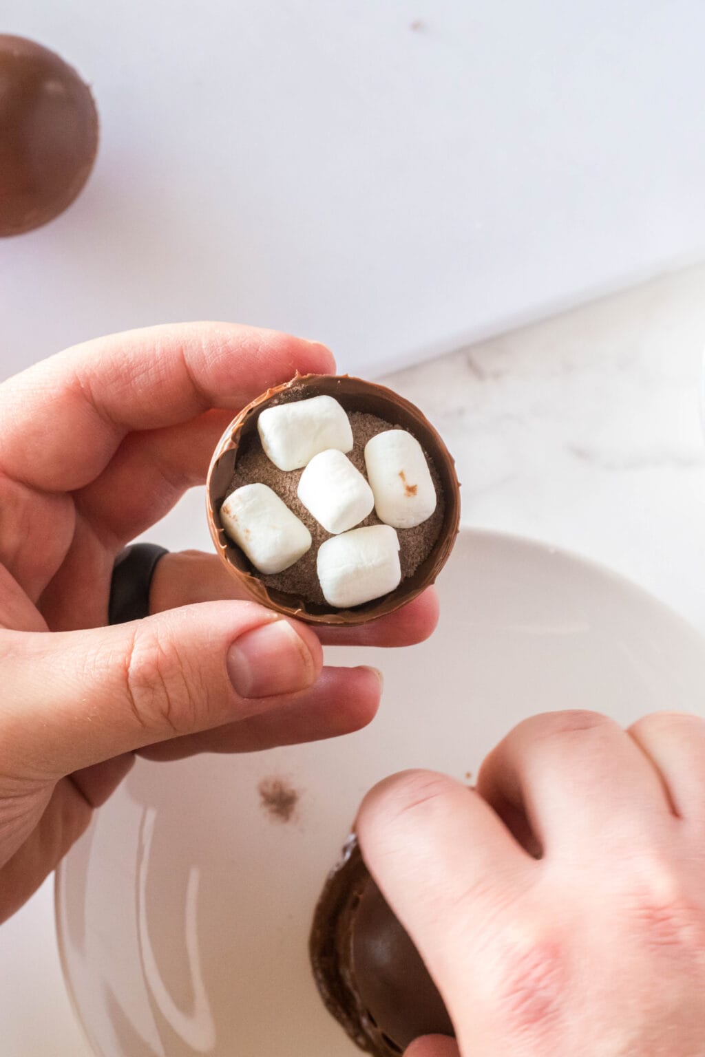 mini marshmallows inside a chocolate ball
