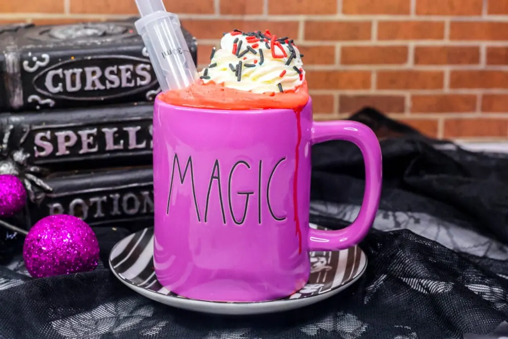 vampire hot cocoa in a purple mug that says magic