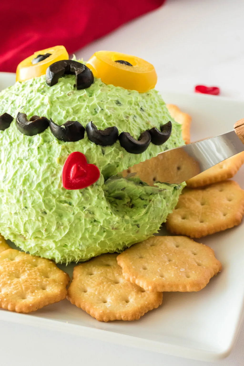 grinch cheese ball being served with knife