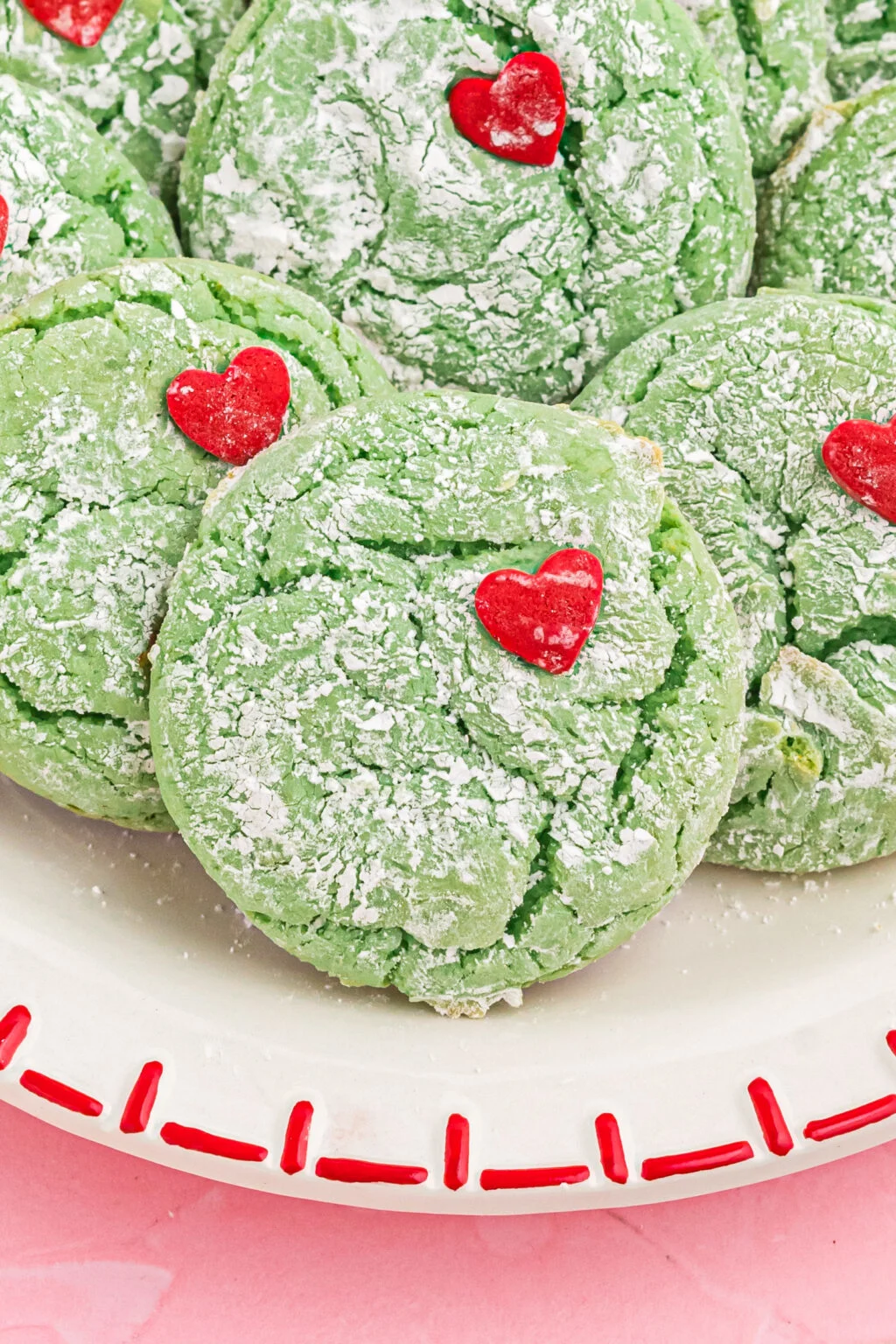 upclose of grinch cookies on a white plate