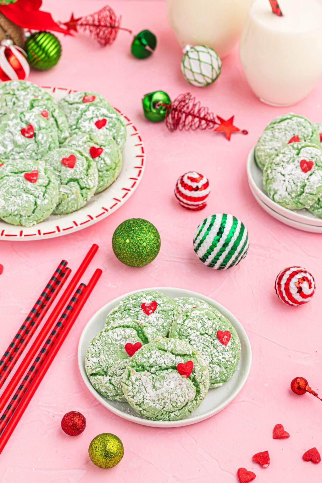 grinch cookies on plate with christmas decorations around it