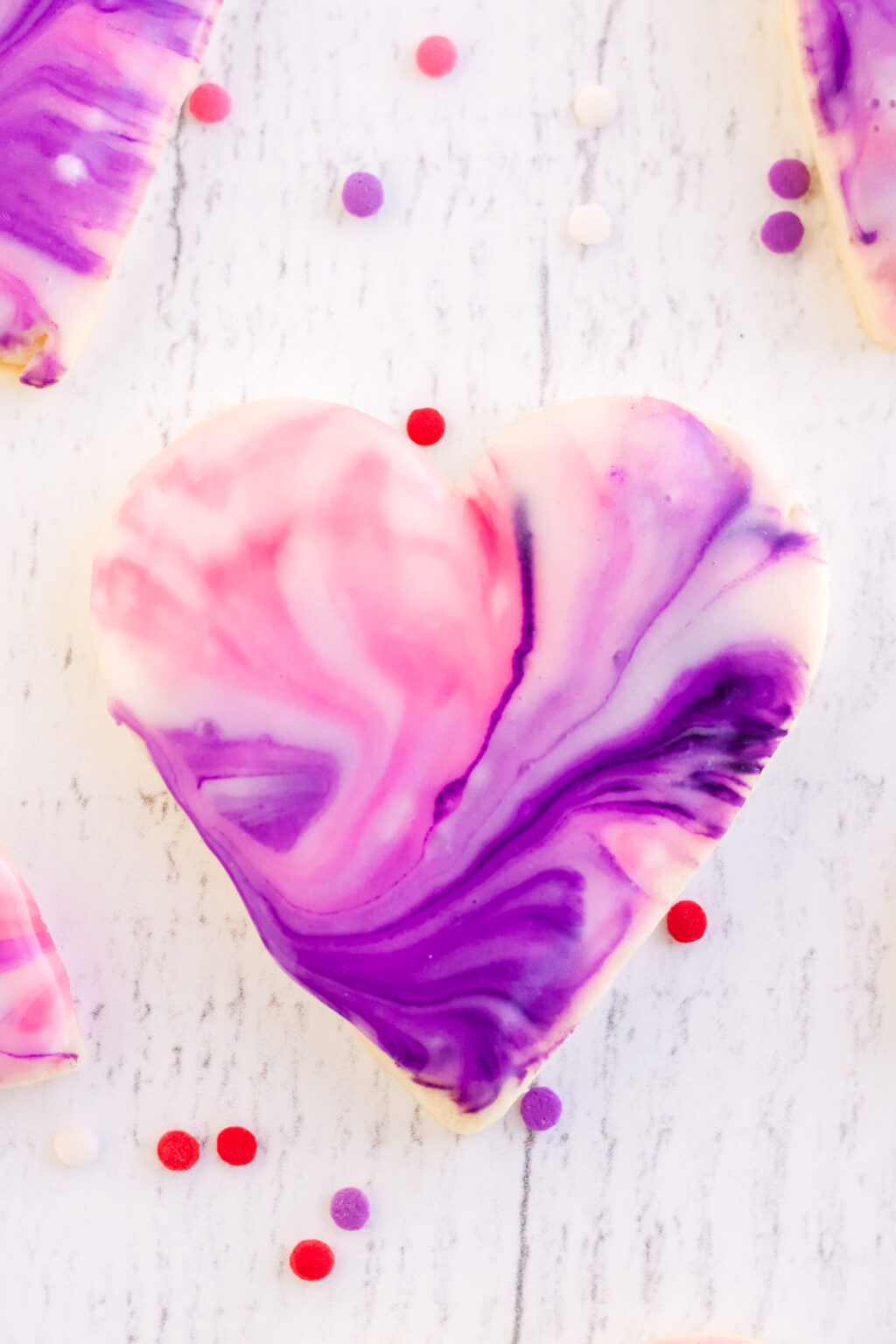 heart cookie covered in marbled frosting