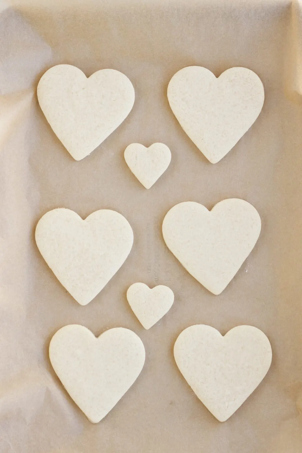 heart cookie dough on a cookie sheet