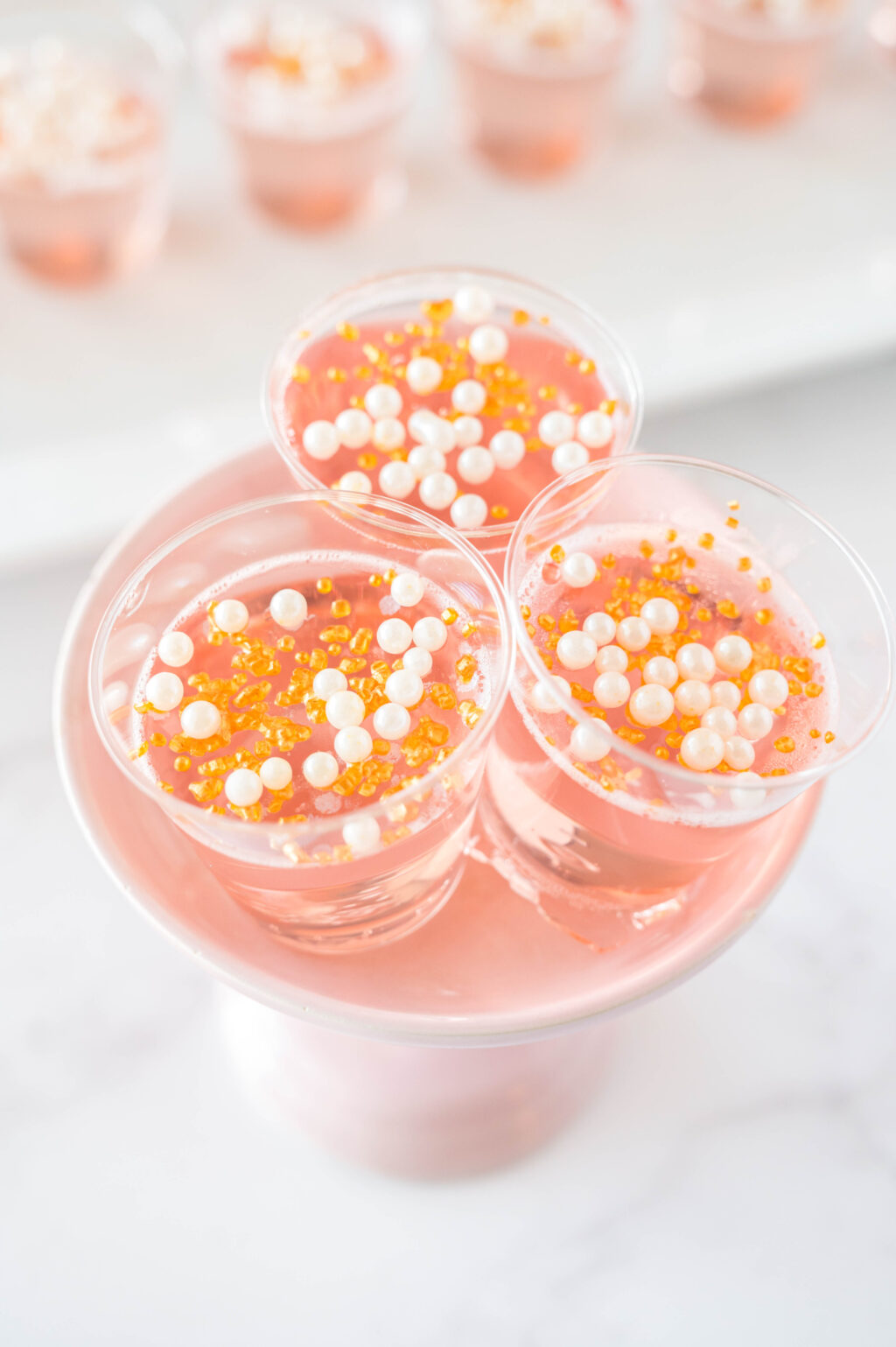pink champagne jello shots on a stand