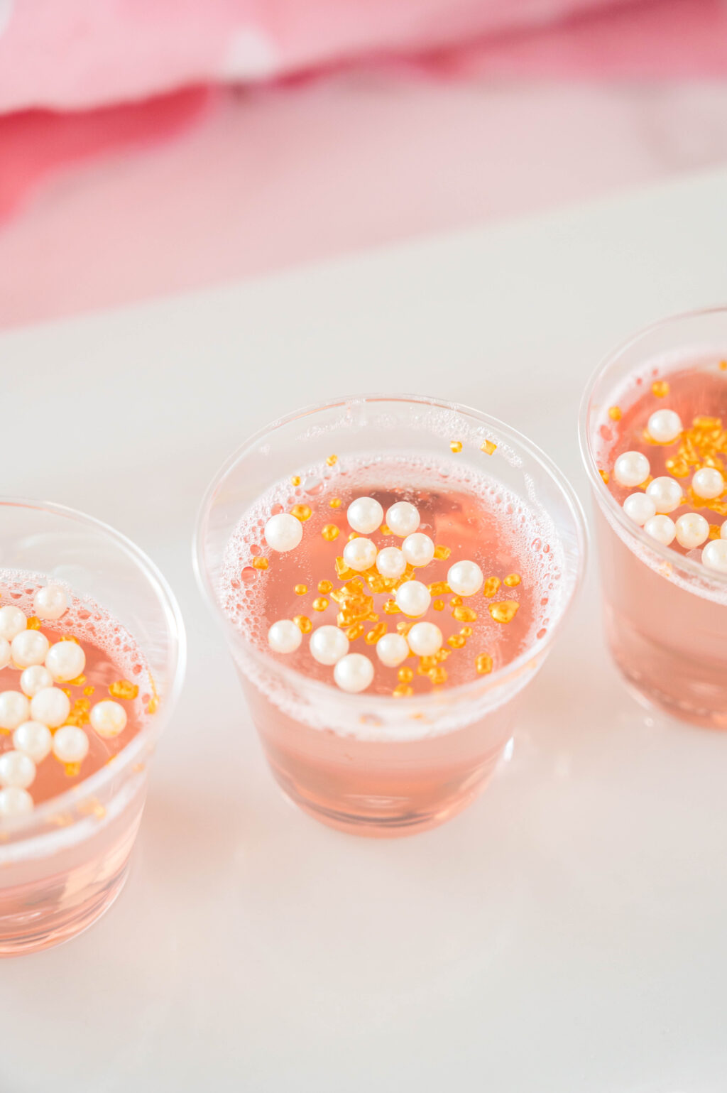 pink champagne jello shots on a plate