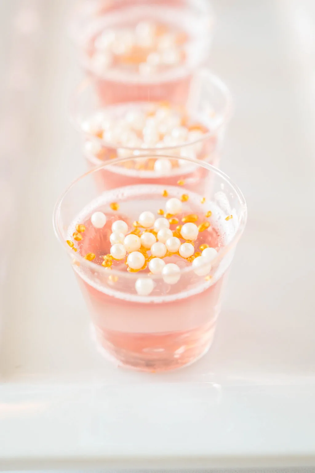 close up of a pink champagne jello shots on a plate