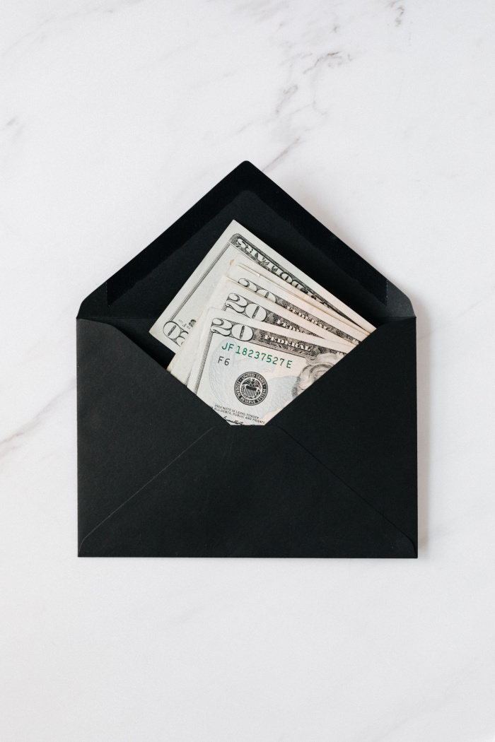 100 envelope challenge with cash stuffed inside black envelope