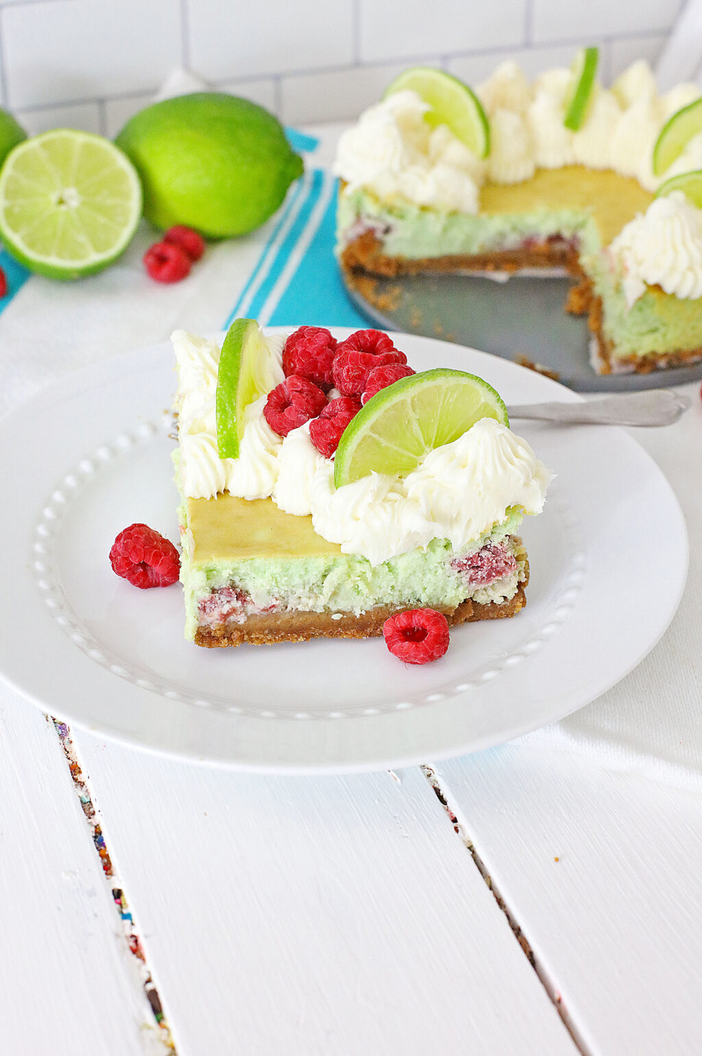 raspberry lime cheesecake slice on a white plate