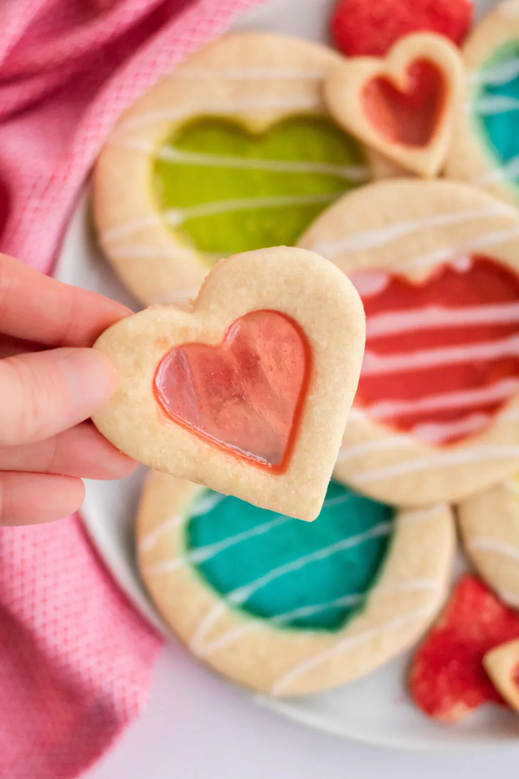 woman holding stained glass cookie