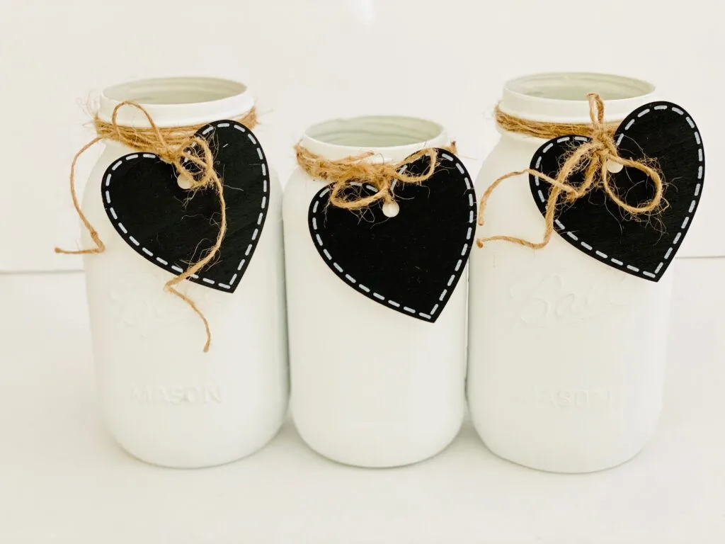 white mason jars with heart tags on them