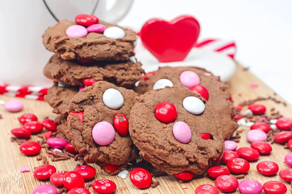 chocolate valentine cookies on a table surrounded by valentine M&Ms