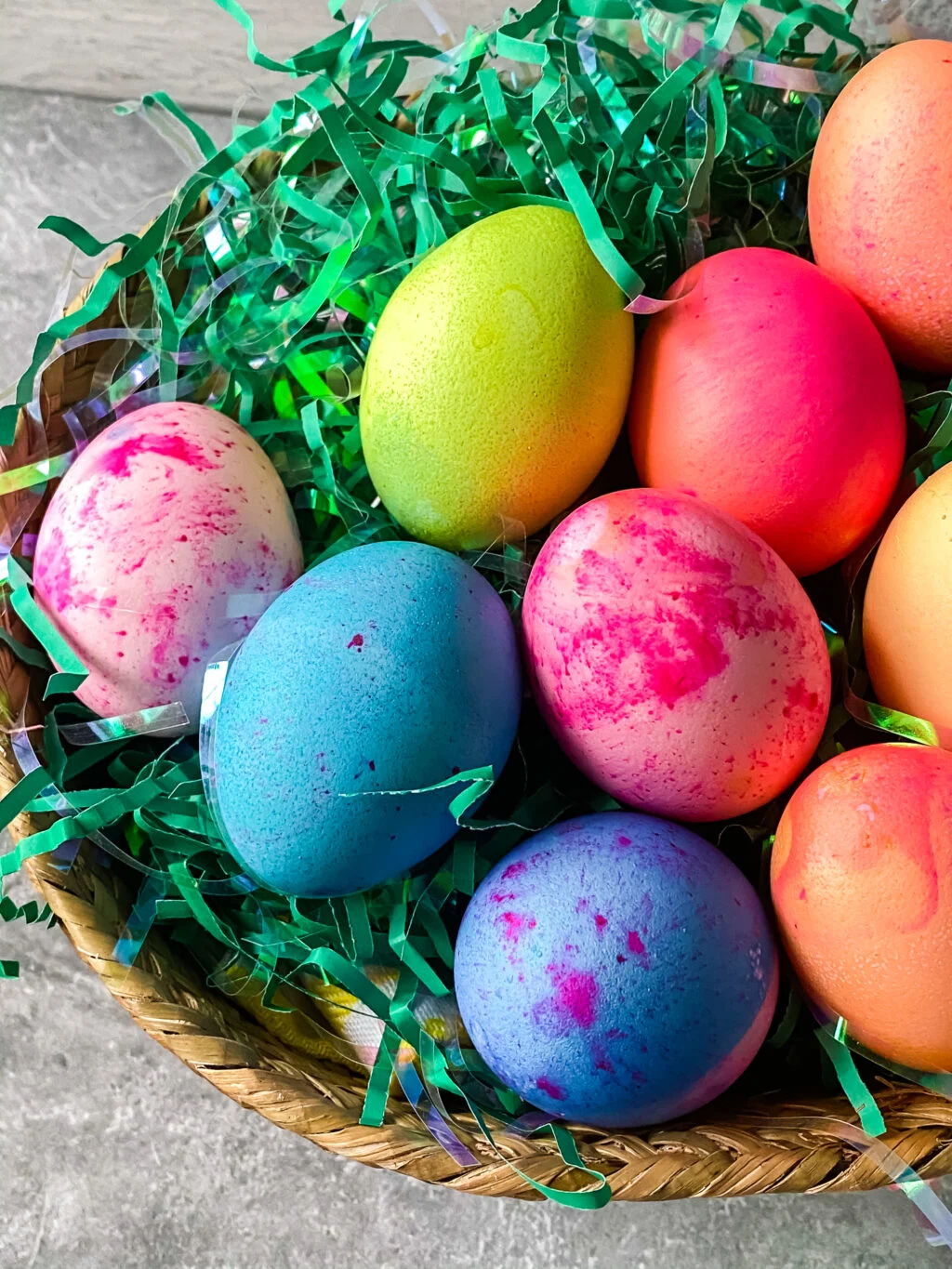 bright colored easter eggs in a basket