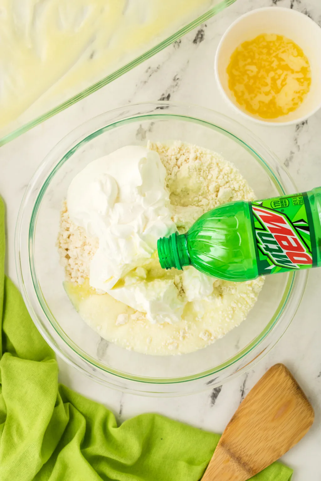 mountain dew being poured into bowl of baking mix