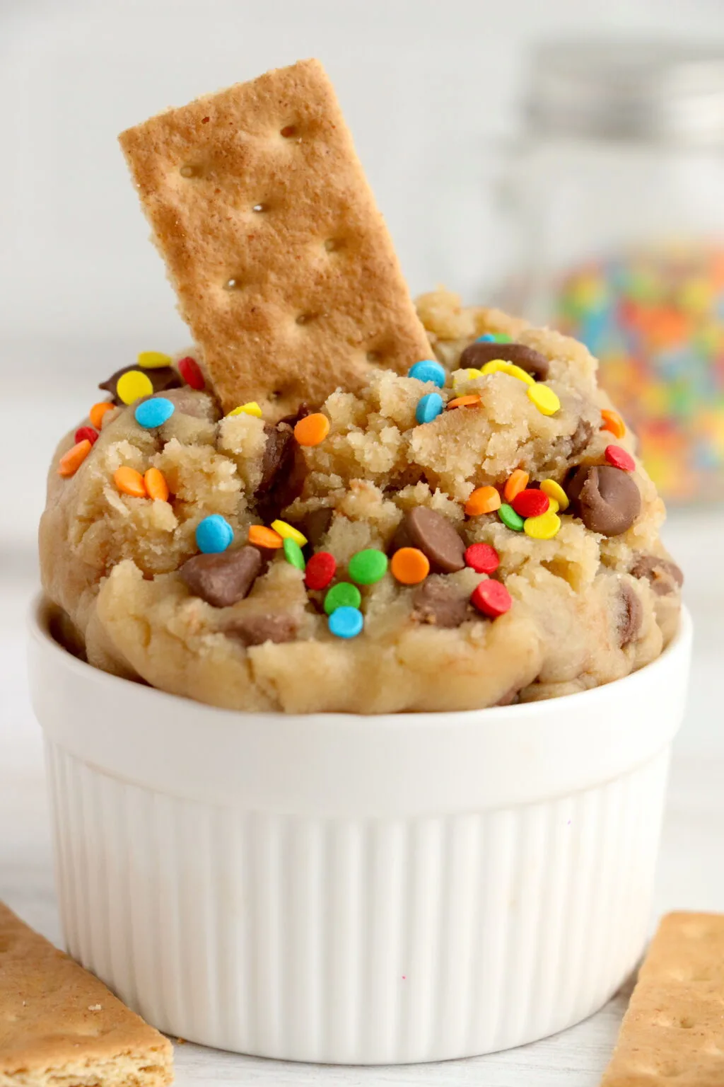edible cookie dough in a container with graham cracker inside